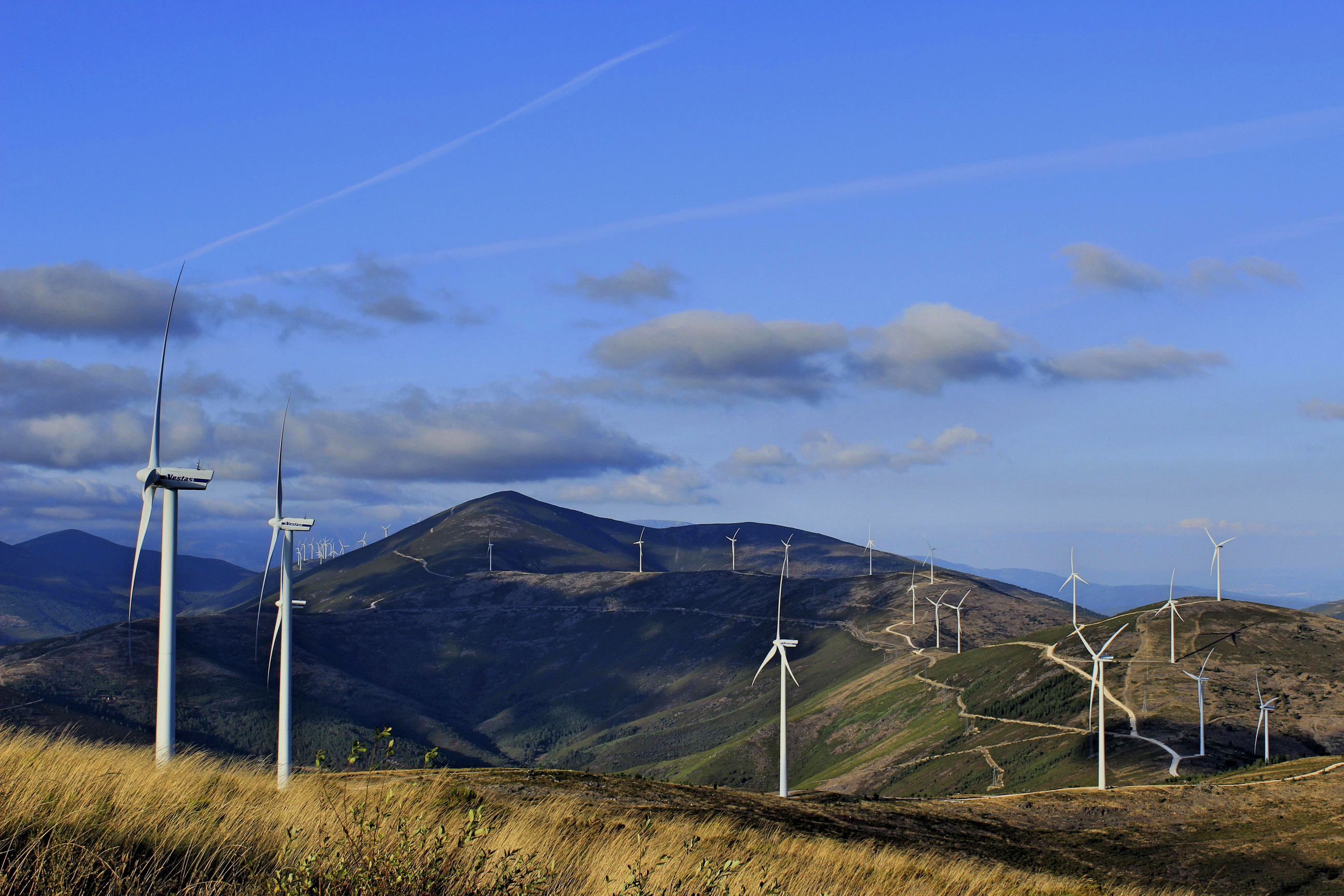 Photo of Wind Turbines Under a a Blue Sky